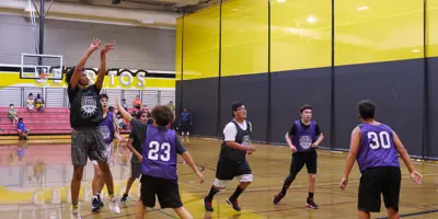 Youth leagues playing basketball indoors at Cerritos High School Gymnasium