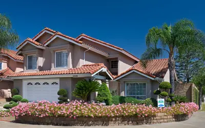 Cerritos home with flower bed and clear blue sky